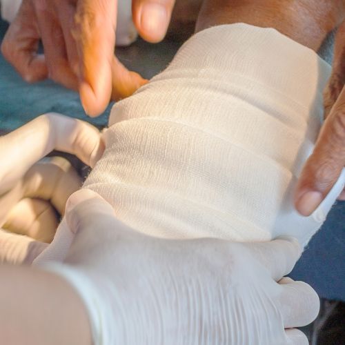 medical team applying a dressing to a wound