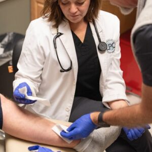 Dr. Heather Hutchings applying topical treatments to a wound